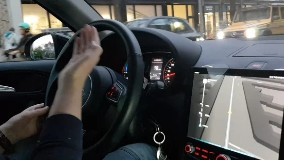 Owner-supplied photographs of gesture interaction in an automotive navigation prototype.