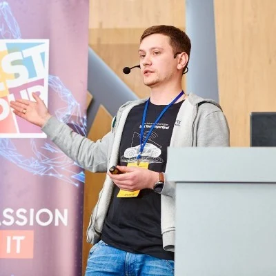 Artem Melnytskyi speaking at a technology event